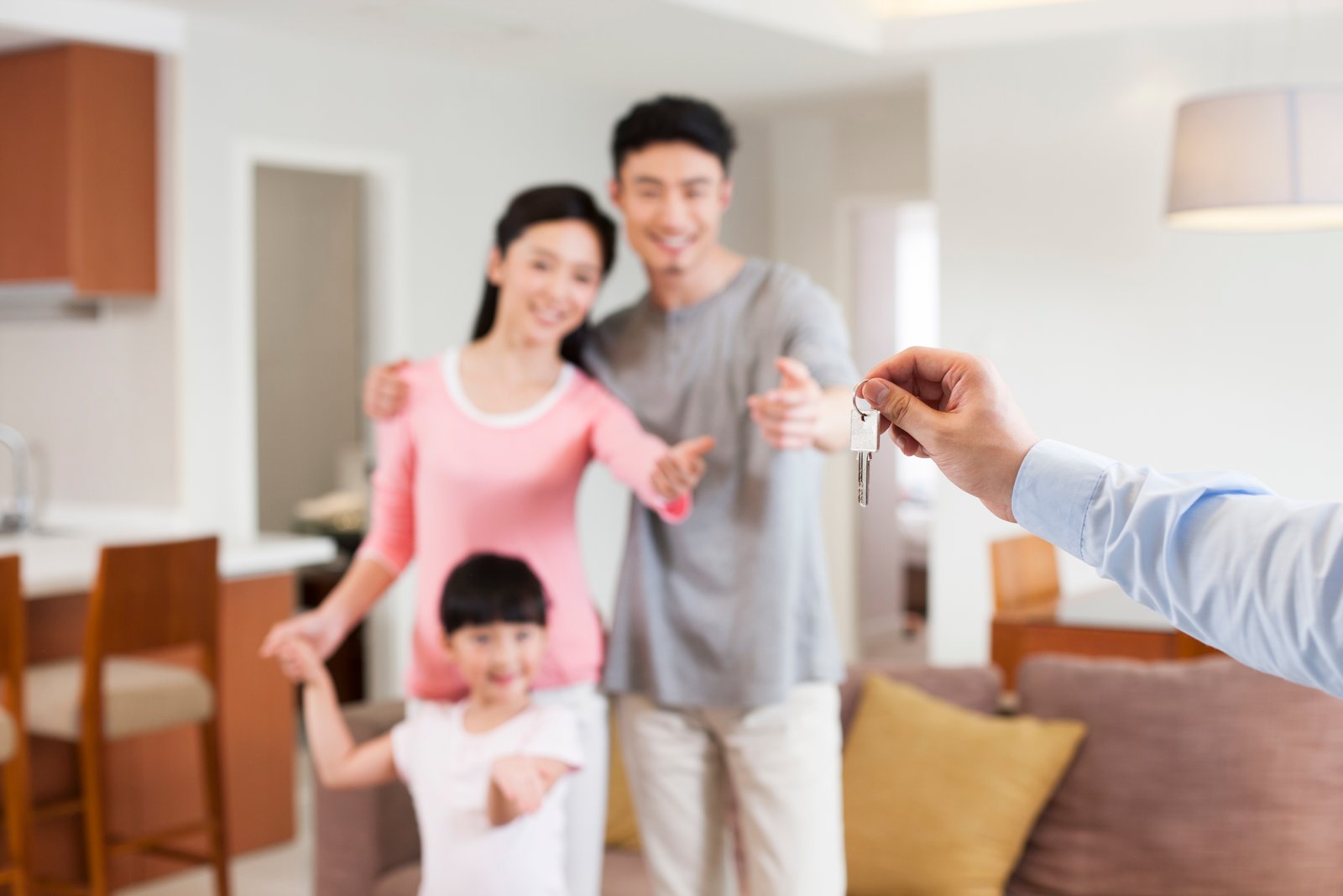 Real estate agent giving family key